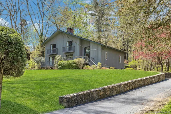 a front view of house with yard and green space