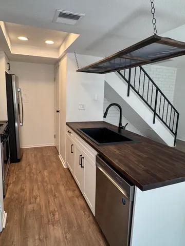 a kitchen with stainless steel appliances granite countertop a sink and a stove