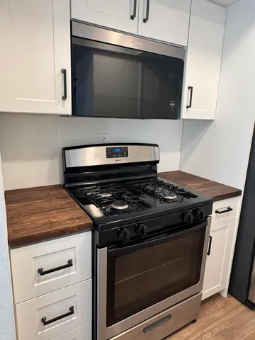 a stove top oven sitting inside of a kitchen