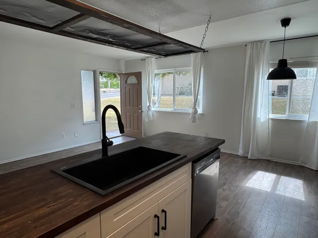 a close view of a sink a counter space and utility room