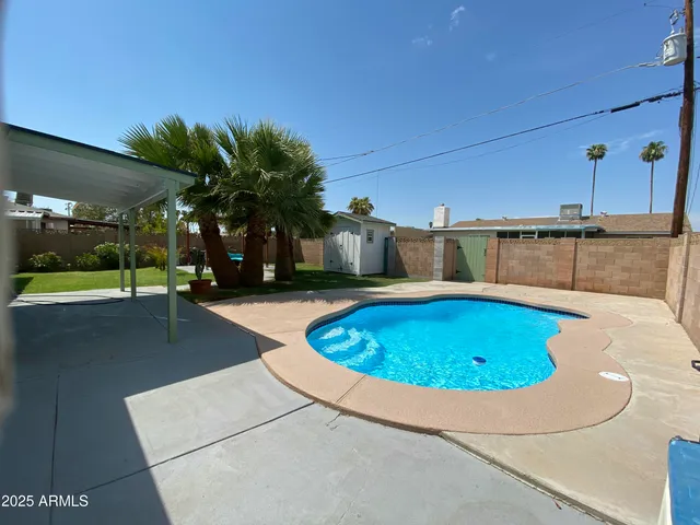 a view of swimming pool in front of house