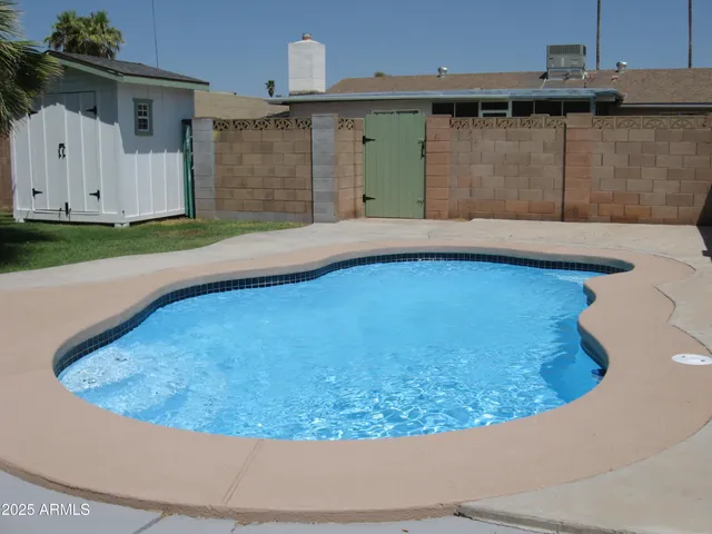 a view of a backyard with jacuzzi