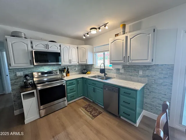 a kitchen with granite countertop a stove top oven sink and cabinets