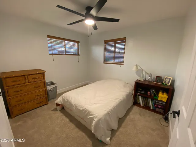 a bedroom with a bed and a tv