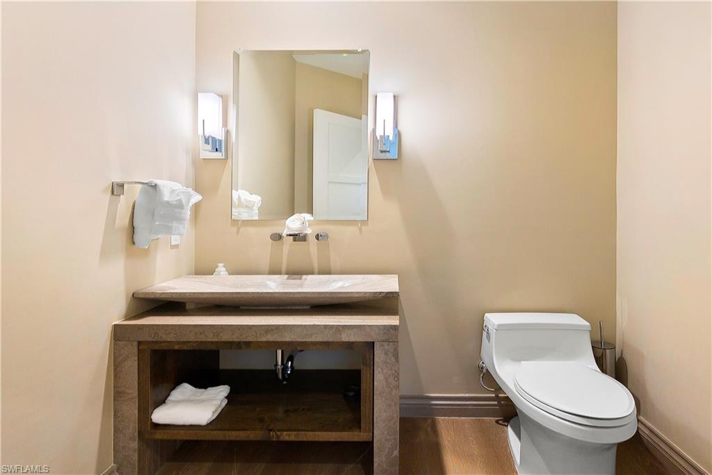 9169 Mercato Way Naples, FL 34108 - Photo 12 of 25 a bathroom with a toilet a sink and mirror