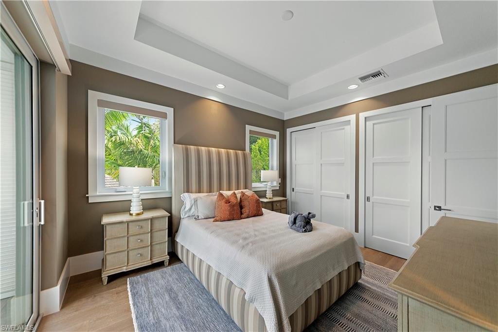 9169 Mercato Way Naples, FL 34108 - Photo 16 of 25 a bedroom with a bed and wooden floor