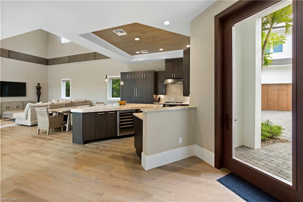 9169 Mercato Way Naples, FL 34108 - Photo 2 of 25 a kitchen with a sink and a stove top oven