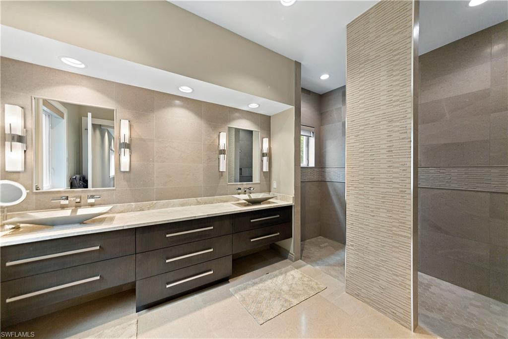 9169 Mercato Way Naples, FL 34108 - Photo 21 of 25 a bathroom with a granite countertop sink a mirror and a shower