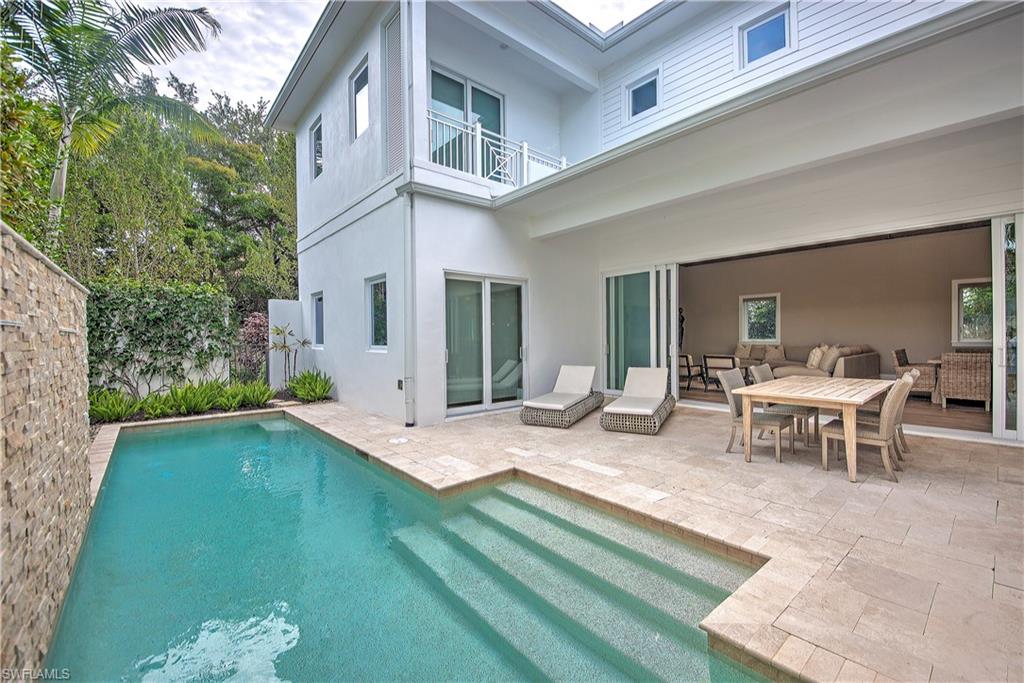 9169 Mercato Way Naples, FL 34108 - Photo 24 of 25 a view of a house with backyard porch and sitting area