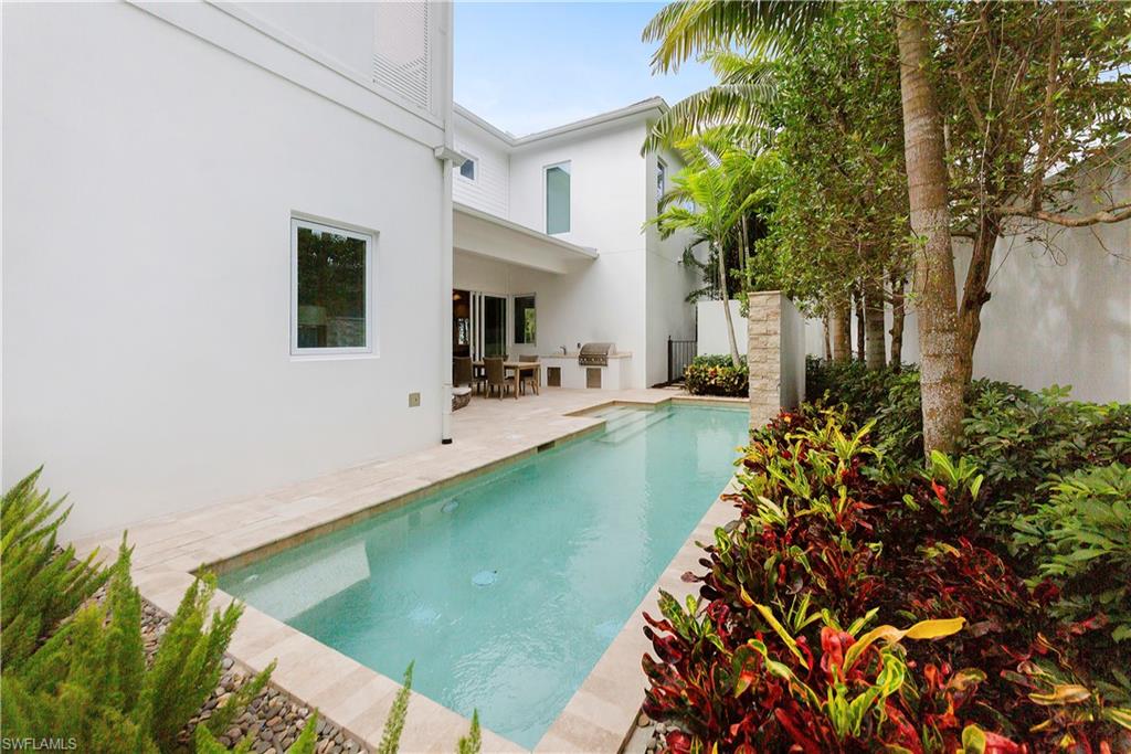 9169 Mercato Way Naples, FL 34108 - Photo 25 of 25 a front view of a house with garden