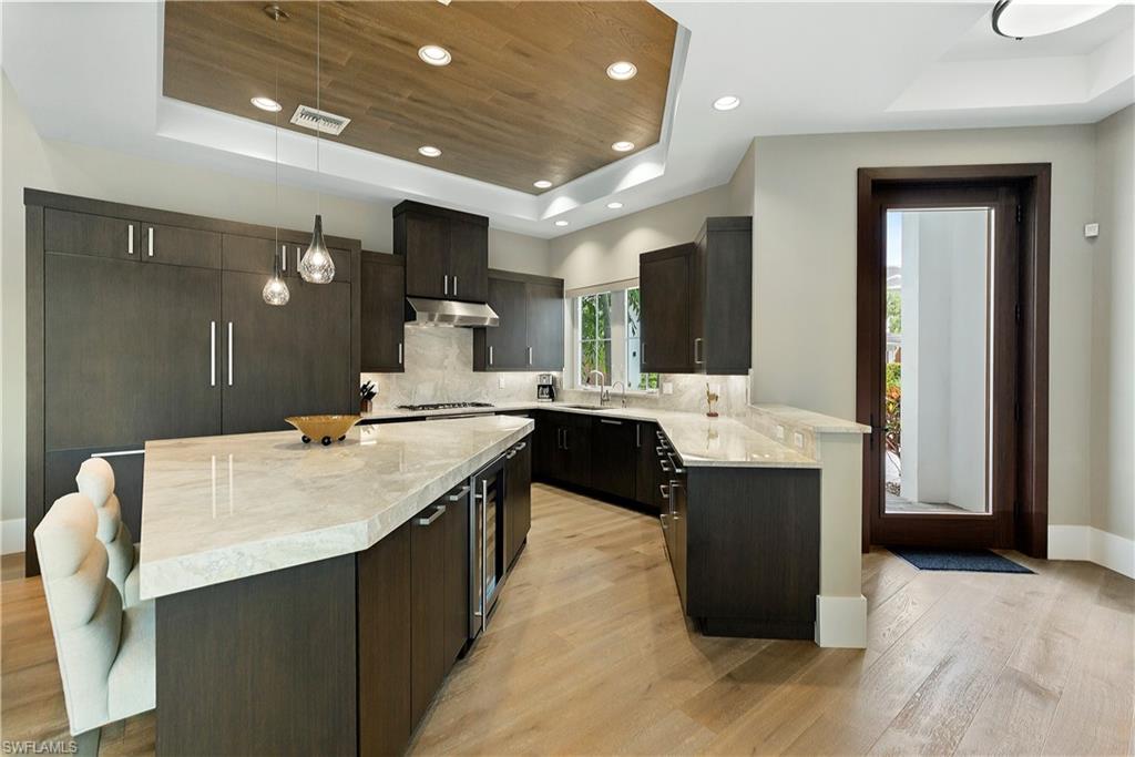 9169 Mercato Way Naples, FL 34108 - Photo 3 of 25 a large kitchen with a table and chairs