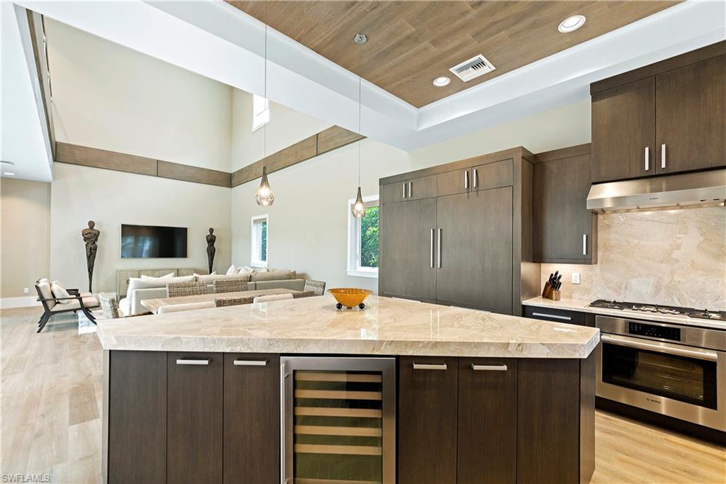 9169 Mercato Way Naples, FL 34108 - Photo 4 of 25 a kitchen with a sink appliances and cabinets