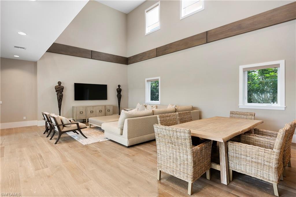9169 Mercato Way Naples, FL 34108 - Photo 5 of 25 a view of a livingroom with furniture and a flat screen tv