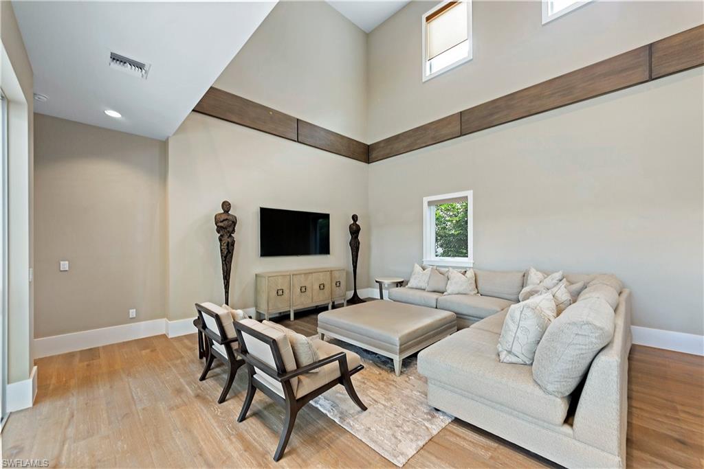 9169 Mercato Way Naples, FL 34108 - Photo 7 of 25 a living room with furniture and a flat screen tv