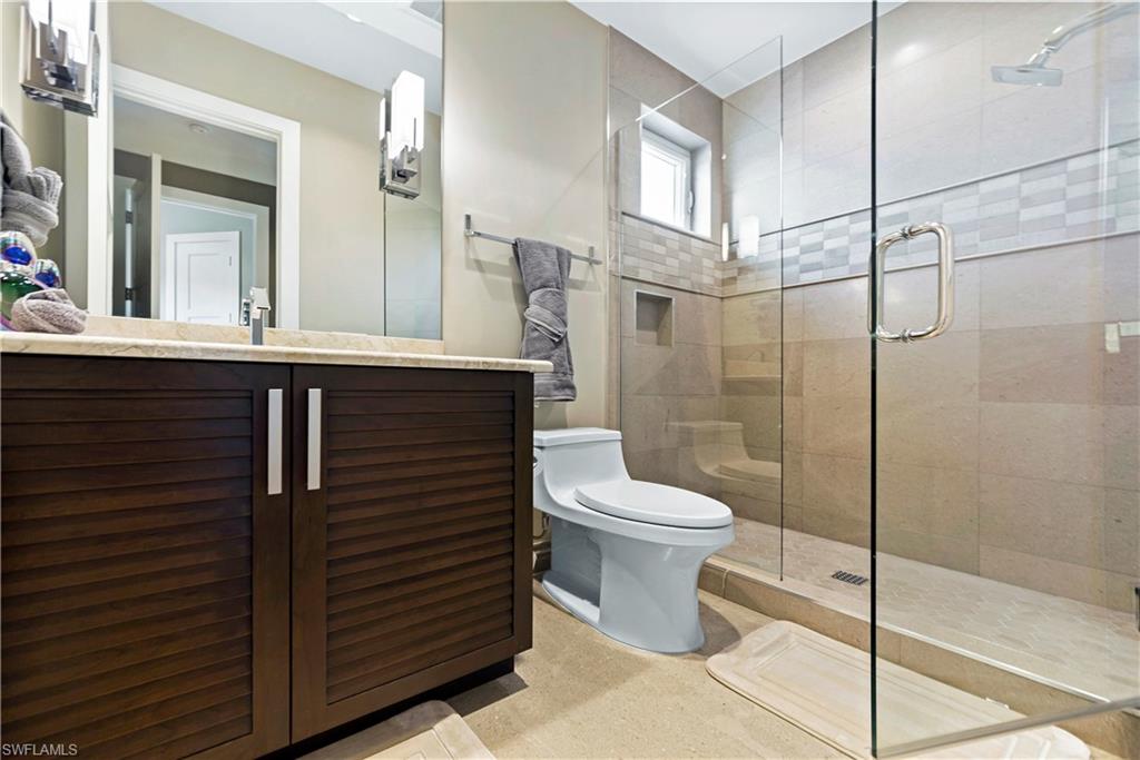 9169 Mercato Way Naples, FL 34108 - Photo 10 of 25 a bathroom with a toilet sink and shower