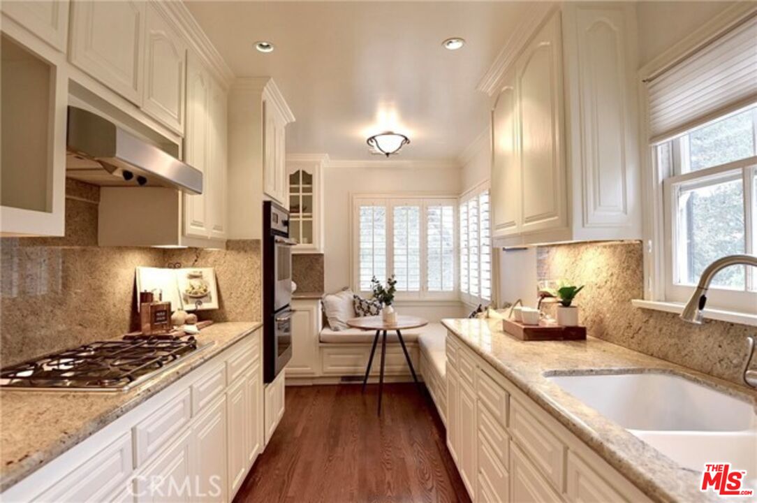 1308 Opechee Way Glendale, CA 91208 - Photo 11 of 33 a large kitchen with stainless steel appliances granite countertop a lot of counter space and a large window