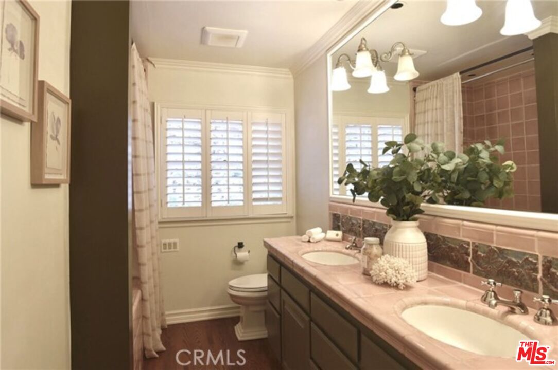 1308 Opechee Way Glendale, CA 91208 - Photo 21 of 33 a bathroom with a granite countertop sink mirror vanity and toilet