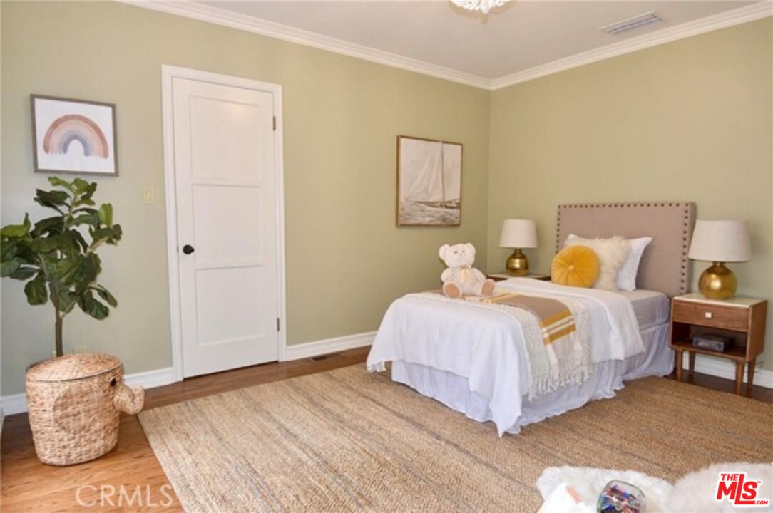 1308 Opechee Way Glendale, CA 91208 - Photo 22 of 33 a bedroom with a bed and a potted plant