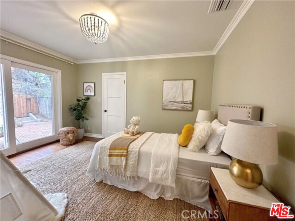1308 Opechee Way Glendale, CA 91208 - Photo 23 of 33 a bedroom with a bed and wooden floor