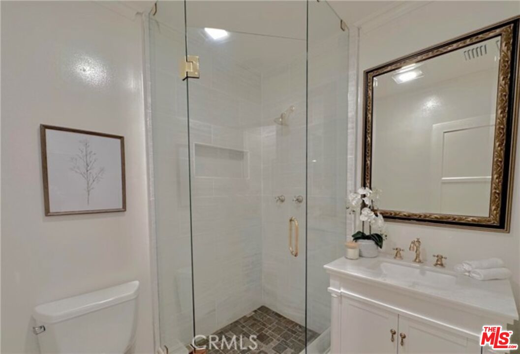 1308 Opechee Way Glendale, CA 91208 - Photo 24 of 33 a bathroom with a shower a sink a toilet and mirror