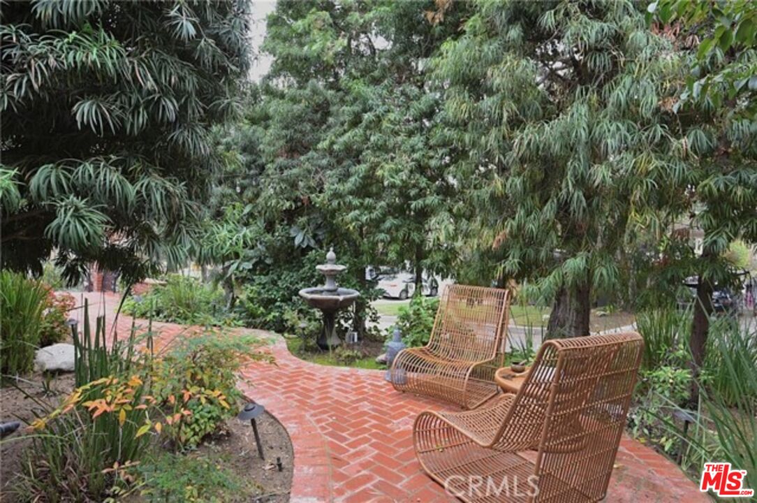 1308 Opechee Way Glendale, CA 91208 - Photo 25 of 33 a view of backyard with a table and chairs with wooden fence and plants