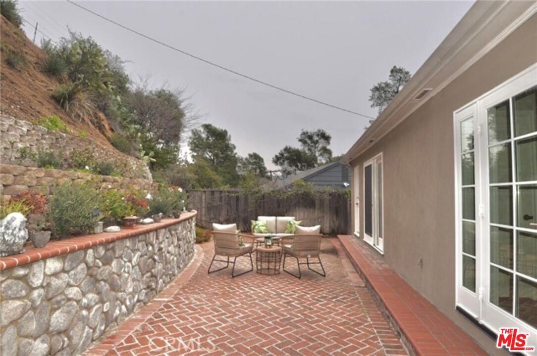 1308 Opechee Way Glendale, CA 91208 - Photo 30 of 33 a chair and table sitting in front of a house