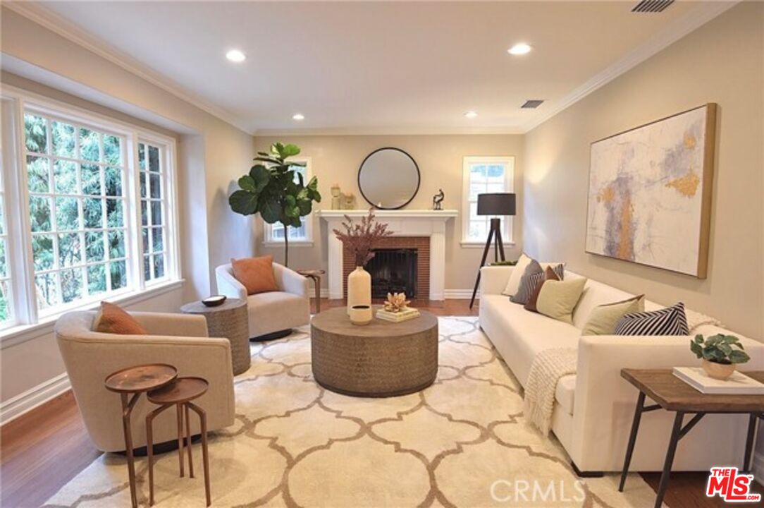 1308 Opechee Way Glendale, CA 91208 - Photo 3 of 33 a living room with furniture a fireplace and a floor to ceiling window