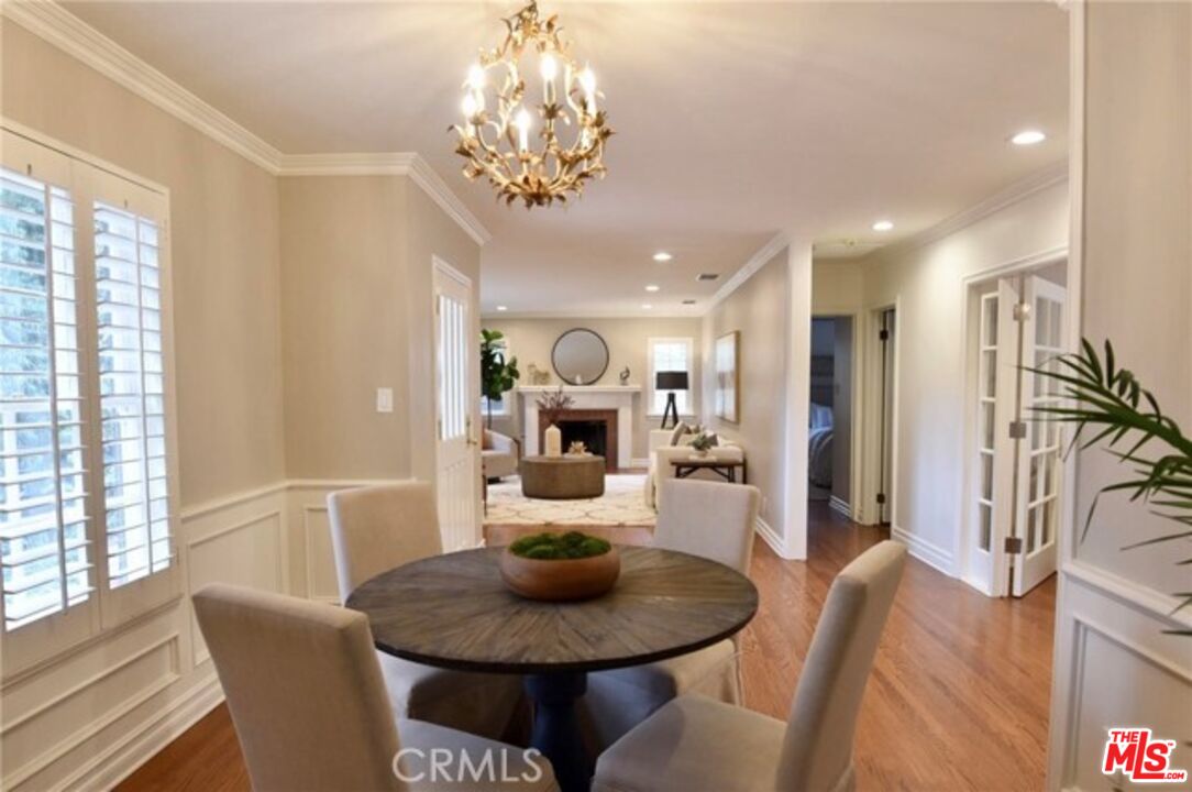 1308 Opechee Way Glendale, CA 91208 - Photo 6 of 33 a dining room with furniture a chandelier and wooden floor