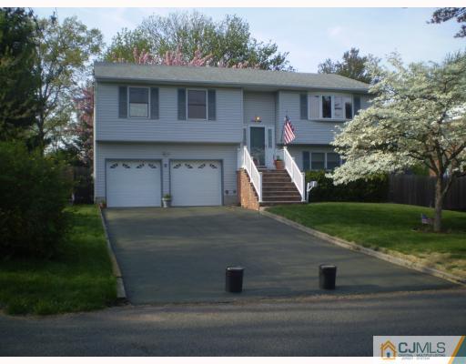 28 Maple Road Iselin, NJ 08830 - Photo 3 of 5 a front view of a house with garden