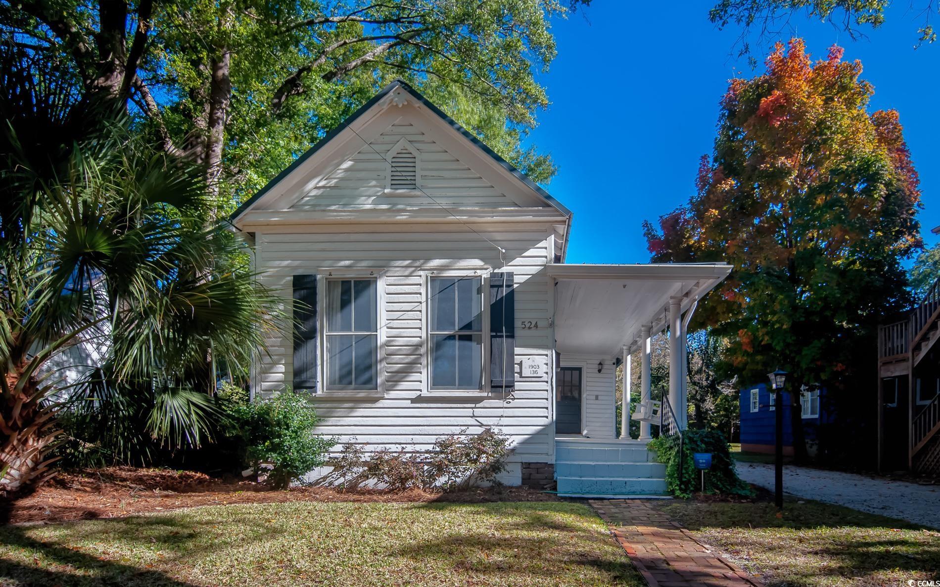 View of front of home with a front yard and a porch