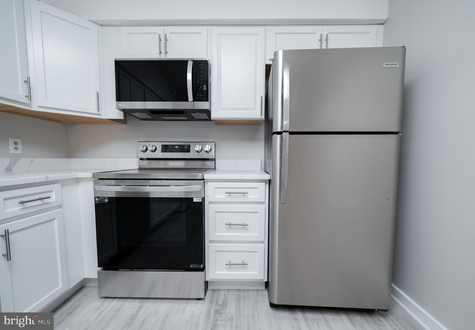 5505 Seminary Road, Unit 103N Falls Church, VA 22041 - Photo 10 of 59 a kitchen with a refrigerator and a stove top oven