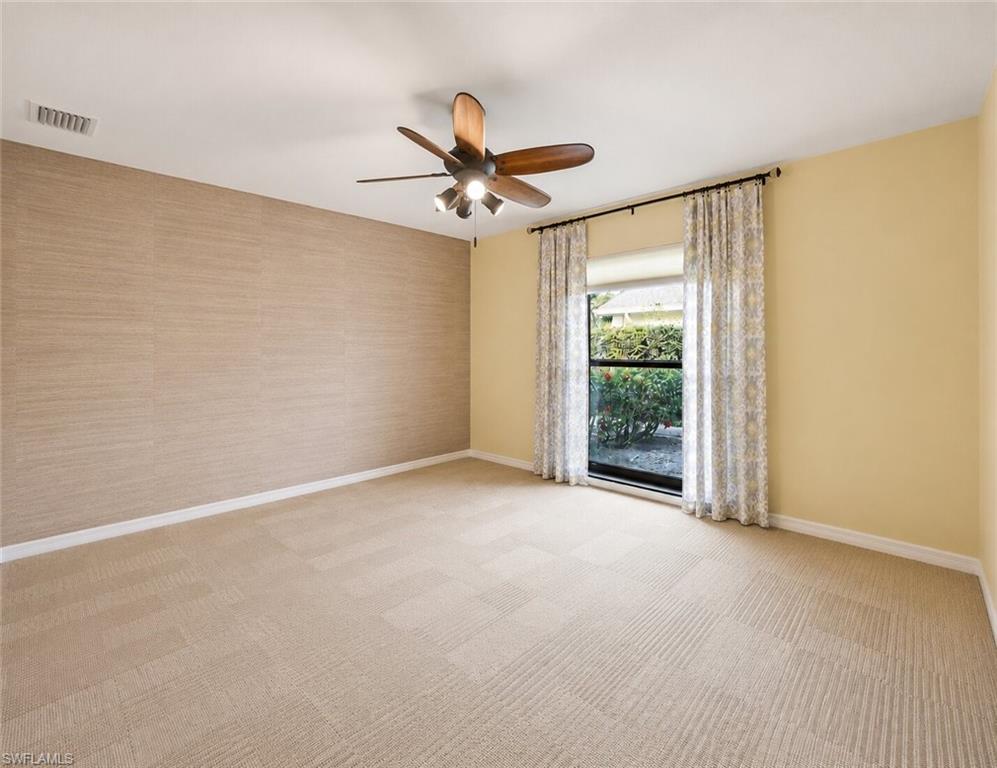 2274 Queens Way Naples, FL 34112 - Photo 18 of 28 a view of a big room with carpet