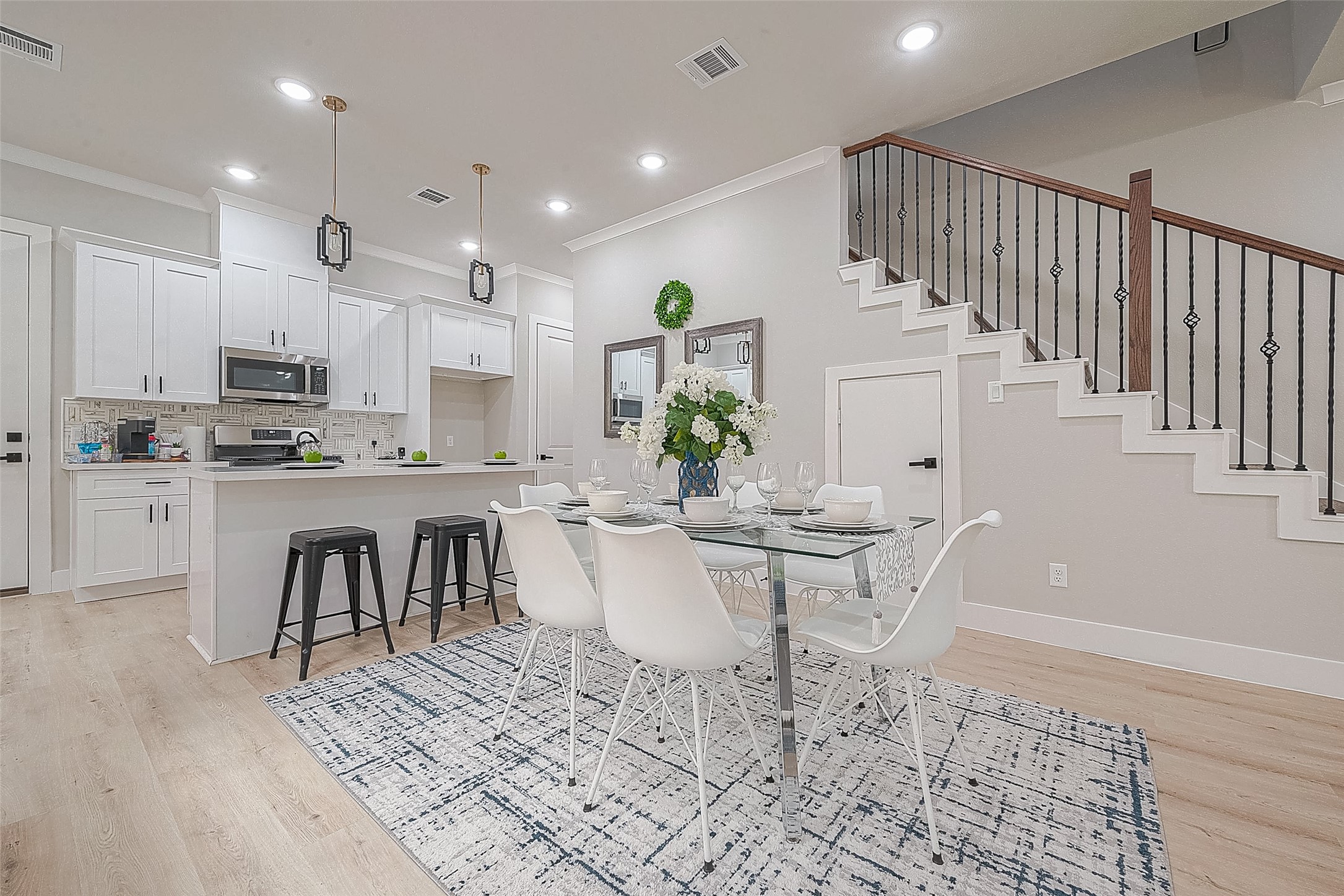 3835 Mainer Street Houston, TX 77021 - Photo 4 of 21 a kitchen with stainless steel appliances kitchen island granite countertop a stove a sink a refrigerator a dining table and chairs with wooden floor