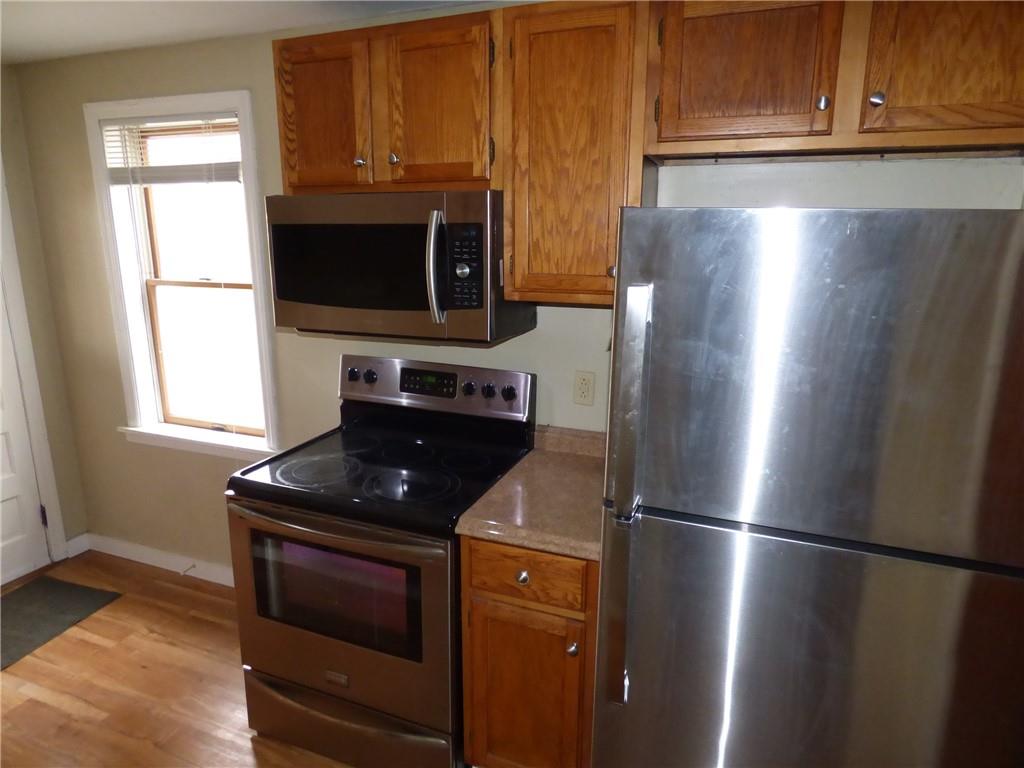 a kitchen with stainless steel appliances wooden cabinets and a refrigerator