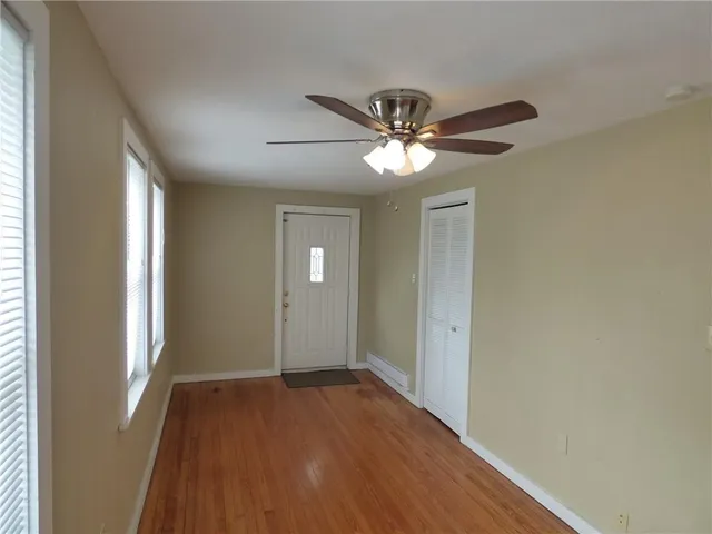 wooden floor in an empty room with a window