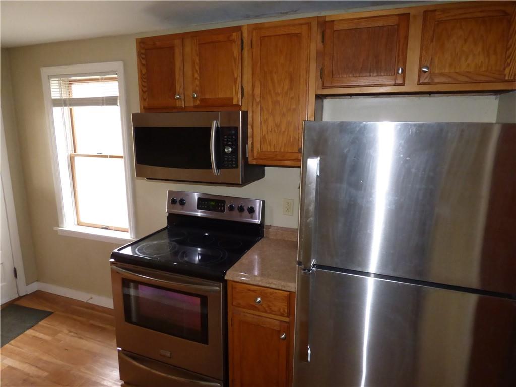 29 East Prospect Avenue, Unit 1 Pittsburgh, PA 15205 - Photo 2 of 30 a kitchen with stainless steel appliances granite countertop a refrigerator stove top oven and sink
