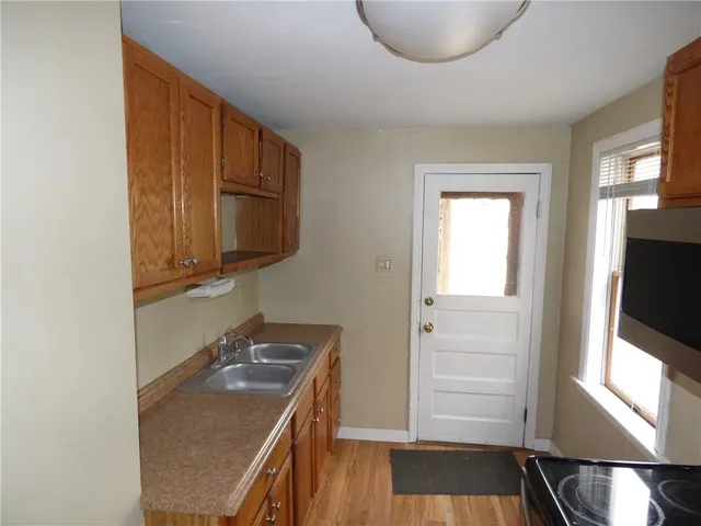 a bathroom with a sink a mirror and wooden floor