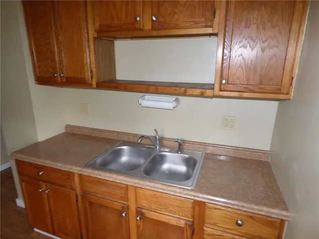 a sink with a granite countertop window