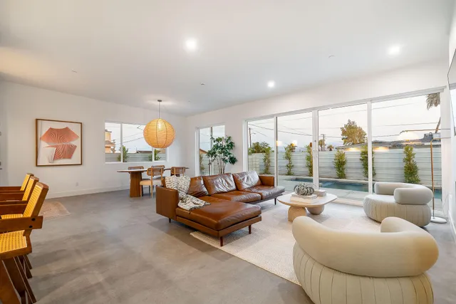 a living room with furniture and potted plant