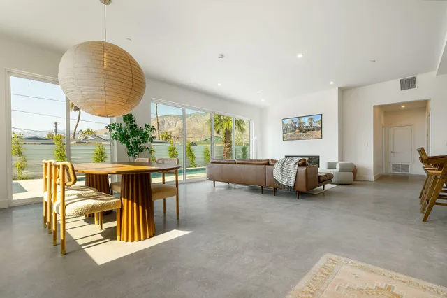 a living room with furniture and kitchen view