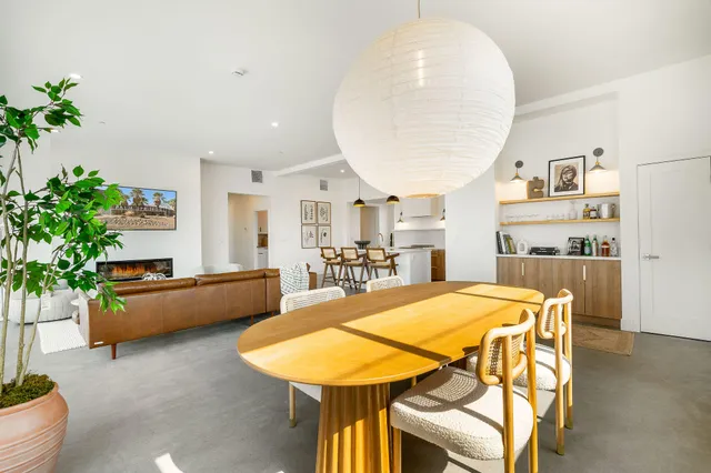 a living room with furniture and kitchen view
