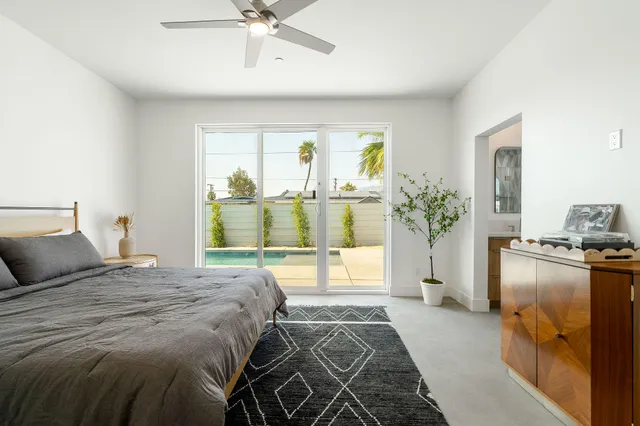 a bedroom with a bed and a potted plant