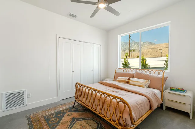 a bedroom with a bed and a window