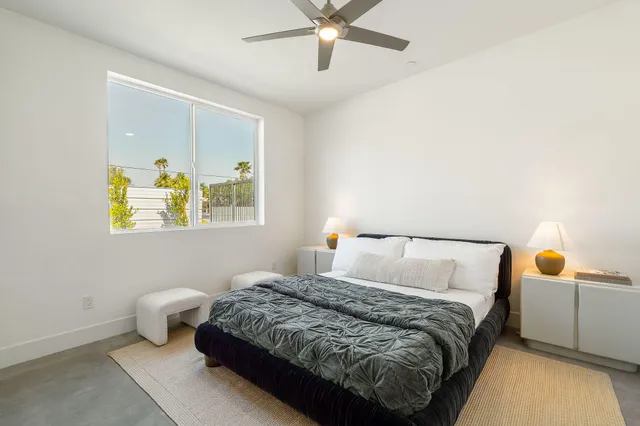 a room with two chair and a window