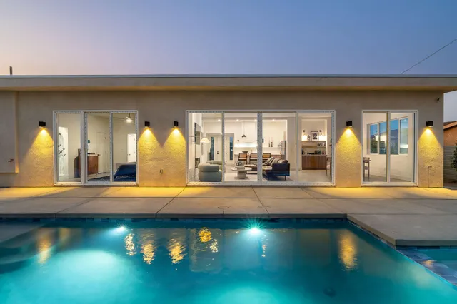 a view of swimming pool with a lounge chairs