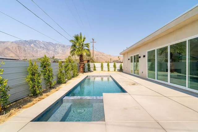 a view of a living room and swimming pool