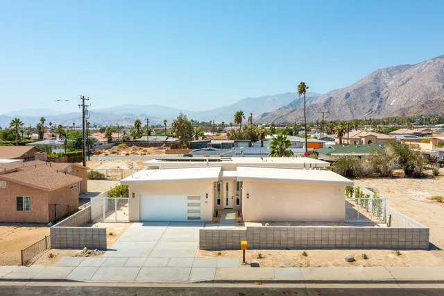 a view of a terrace with a table and chairs