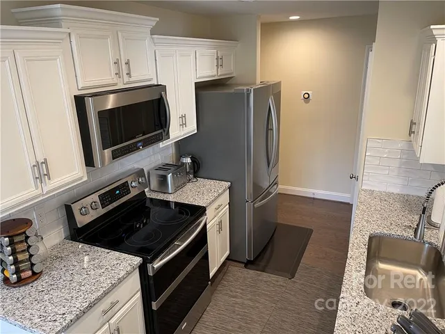 a kitchen with a stove microwave and refrigerator