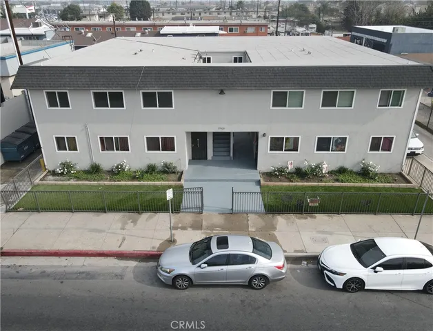 a front view of a house with a garden and plants