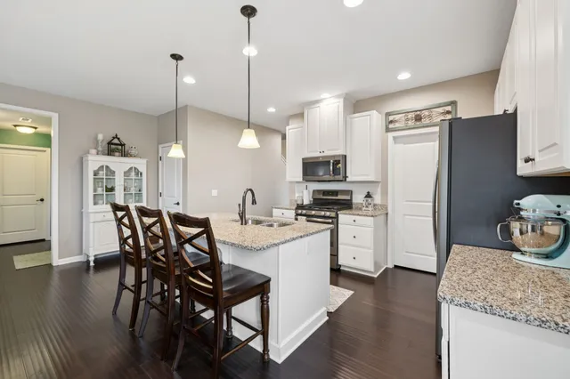 a spacious bedroom with a bed and a ceiling fan